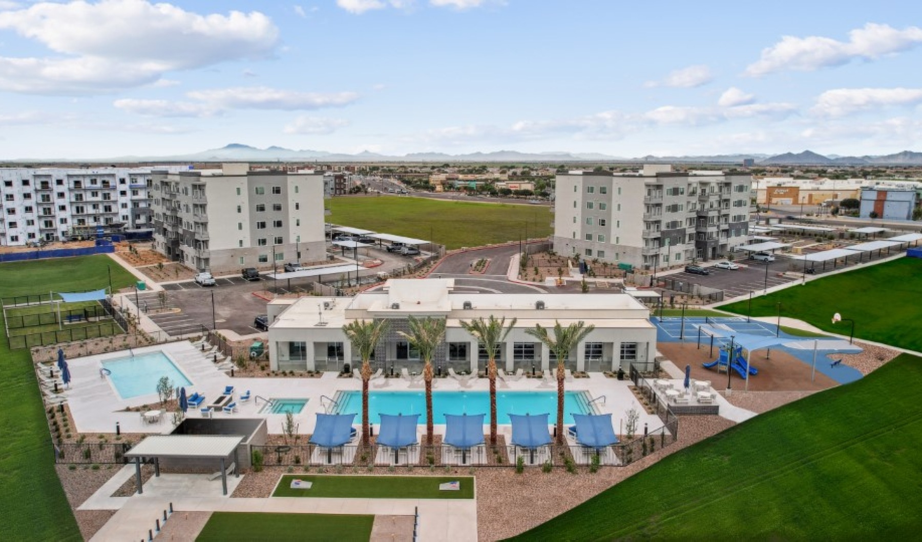 ariel view of an apartment complex with a pool 