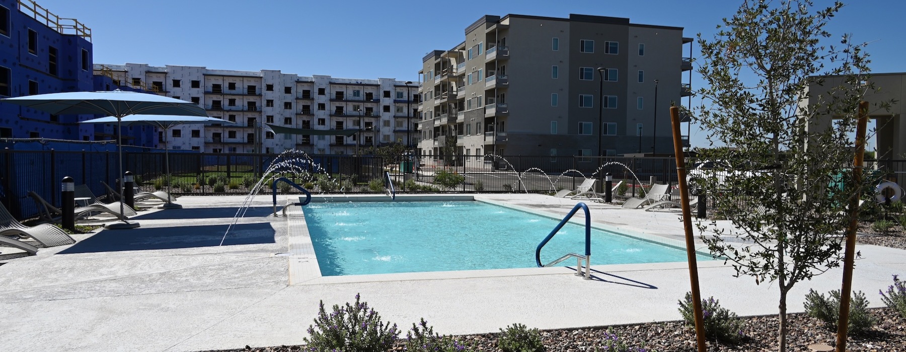 Resort-style swimming pool with lounge seating